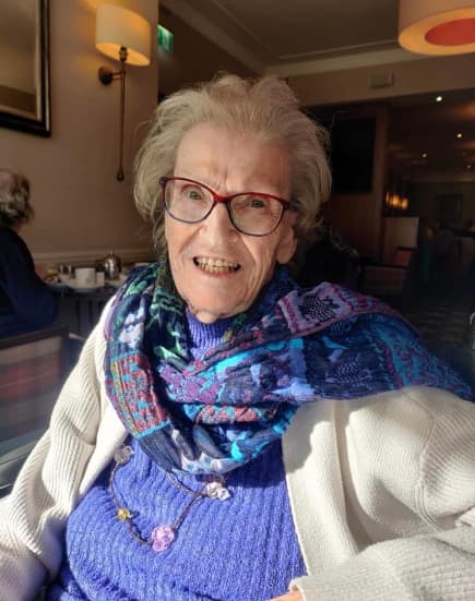 Residents enjoying afternoon tea at the Atholl Hotel, seated at a beautifully set table, smiling and sharing stories in a warm and welcoming atmosphere.